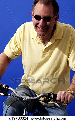 Man riding a bicycle View Large Photo Image Picture - Man riding a bicycle. Fotosearch