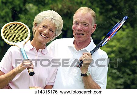 Stock Photograph - Senior couple with tennis rackets. Fotosearch