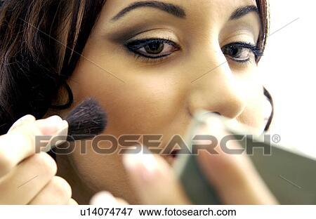 Stock Photo - Woman applying makeup. Fotosearch