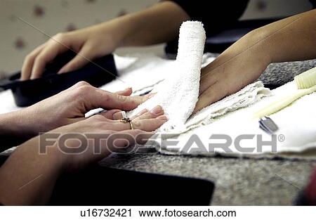Stock Image - Woman getting a manicure. Fotosearch