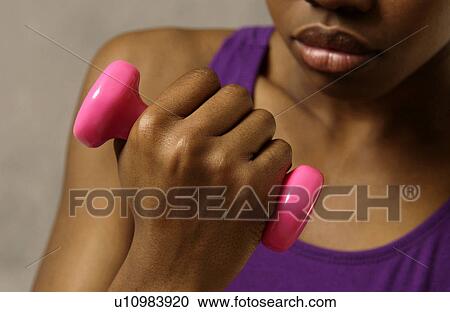Stock Image - Woman lifting weights. Fotosearch
