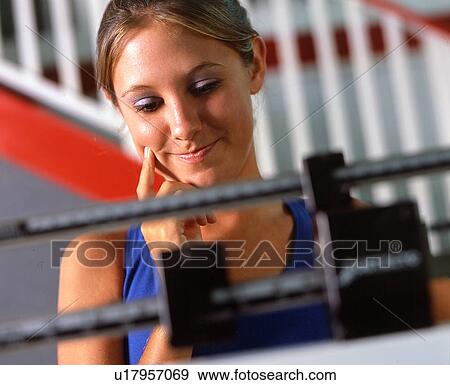 Stock Photo - Woman on scale. Fotosearch
