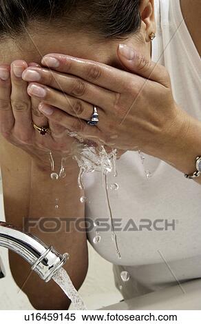 Woman washing her face View Large Photo Image Stock Photography - Woman washing her face. Fotosearch