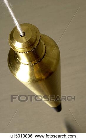 Brass plumb bob hanging over metallic surface View Large Photo Image Stock Photograph - Brass plumb bob hanging over metallic surface. Fotosearch