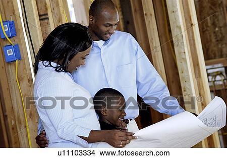 Family looking at their new home plans View Large Photo Image Picture - Family looking at their new home plans. Fotosearch
