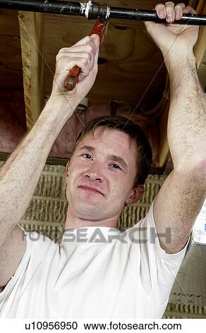 Man fixing plumbing View Large Photo Image Stock Image - Man fixing plumbing. Fotosearch