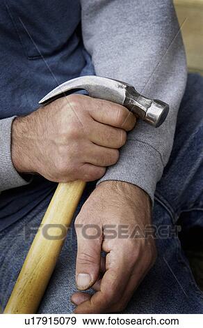 Man holding hammer View Large Photo Image Stock Photo - Man holding hammer. Fotosearch