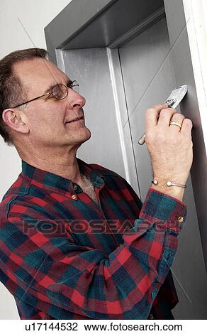 Stock Image - Man painting. Fotosearch