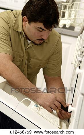 Stock Photo - Man repairing dishwasher. Fotosearch