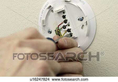Man repairing thermostat View Large Photo Image Picture - Man repairing thermostat. Fotosearch