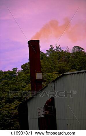 Factory chimney letting out red smoke View Large Photo Image Stock Image - Factory chimney letting out red smoke. Fotosearch