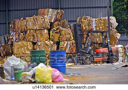 Forklift in a junkyard, with garbage and oil drums View Large Photo Image Stock Image - Forklift in a junkyard, with garbage and oil drums. Fotosearch