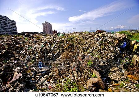 Large piles of garbage and junk at a garbage dump View Large Photo Image Stock Photo - Large piles of garbage and junk at a garbage dump. Fotosearch