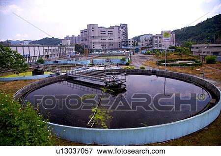 Stock Photo - Outdoors sewage treatment plant in the city. Fotosearch