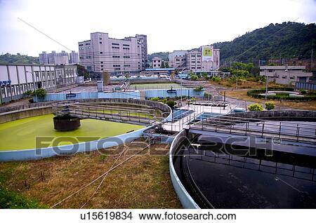 Picture - Sewage treatment plant next to the mountains. Fotosearch