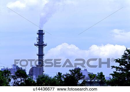 Stock Photo - Smoke coming out from a tall industrial chimney. Fotosearch