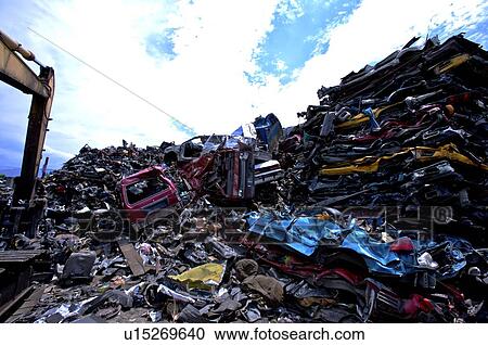 Stock Image - Stacks of compressed cars in a junkyard. Fotosearch