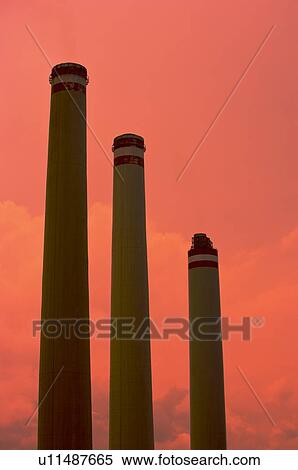 Stock Photography - Tall industrial chimneys, in a row. Fotosearch