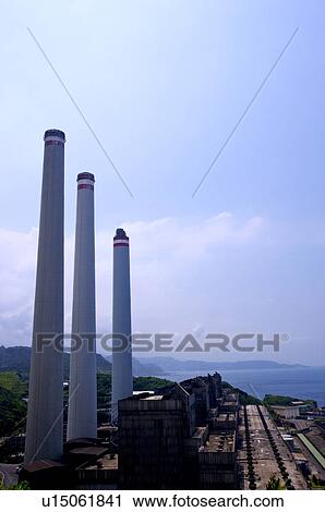 Three tall industrial chimneys in a row, next to a factory plant View Large Photo Image Stock Image - Three tall industrial chimneys in a row, next to a factory plant. Fotosearch