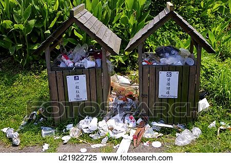 Two overflowing garbage bins side by side, with garbage on the ground View Large Photo Image Stock Photography - Two overflowing garbage bins side by side, with garbage on the ground. Fotosearch