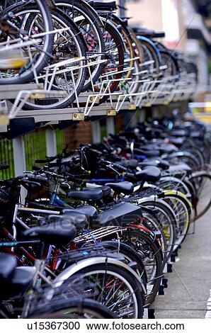 Stock Image - Two rows of bicycles in a parking lot. Fotosearch