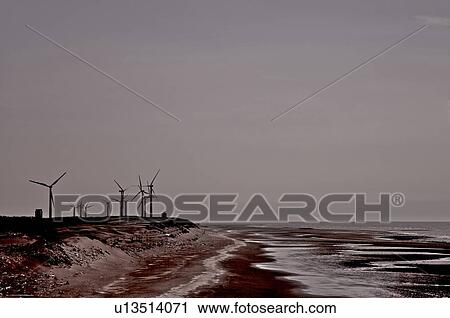 Stock Image - Wind turbines on a bay, by the sea. Fotosearch