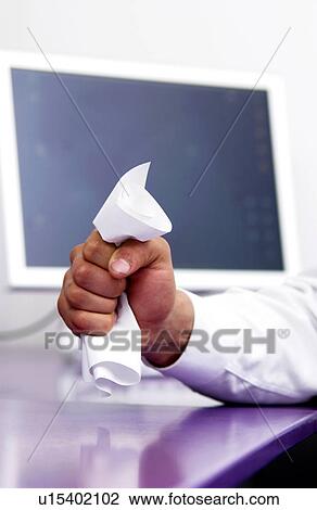 Stock Image - Businessman at desk crumpling paperwork. Fotosearch