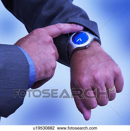 Stock Image - Businessman checking watch. Fotosearch