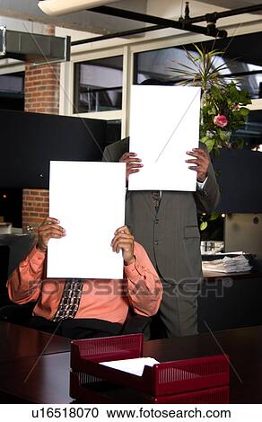 Stock Image - Businessman holding signs in front of them. Fotosearch