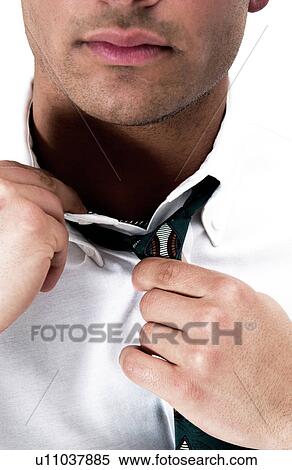 Stock Photography - Businessman loosening his tie. Fotosearch