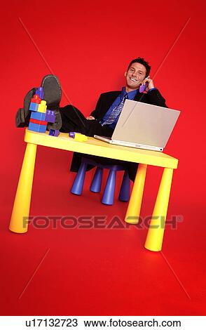 Stock Image - Businessman talking on phone. Fotosearch