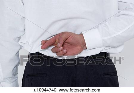 Businessman with fingers crossed behind his back View Large Photo Image Stock Image - Businessman with fingers crossed behind his back. Fotosearch