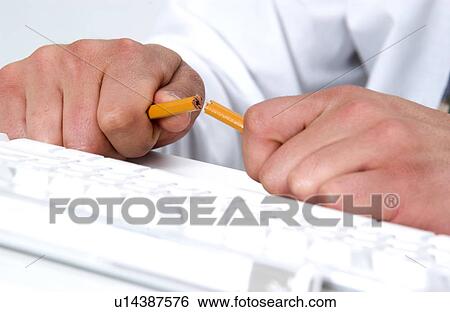 Man at computer breaking a pencil View Large Photo Image Stock Photograph - Man at computer breaking a pencil. Fotosearch