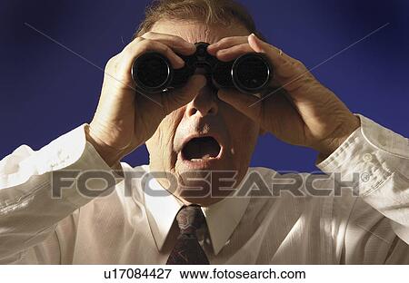 Man looking through binoculars View Large Photo Image Stock Photo - Man looking through binoculars. Fotosearch