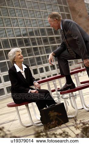 Businessman and businesswoman talking View Large Photo Image Picture - Businessman and businesswoman talking. Fotosearch