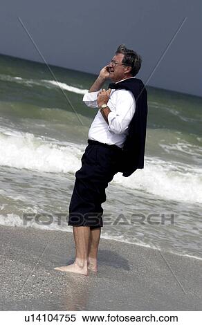 Stock Photography - Businessman at the beach. Fotosearch