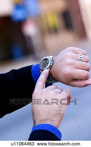 Stock Image - Businessman checking his watch. Fotosearch