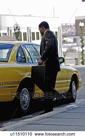 Businessman getting into cab View Large Photo Image Stock Image - Businessman getting into cab. Fotosearch