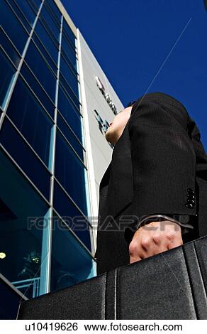 Businessman in front of office View Large Photo Image Stock Photograph - Businessman in front of office. Fotosearch