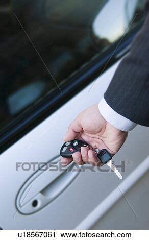 Businessman locking or unlocking car door View Large Photo Image Stock Image - Businessman locking or unlocking car door. Fotosearch