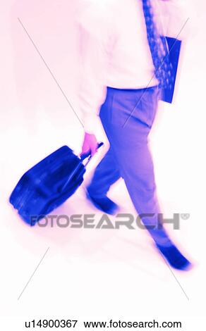 Stock Photo - Businessman pulling luggage. Fotosearch
