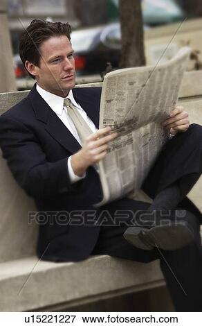 Stock Photo - Businessman reading newspaper. Fotosearch
