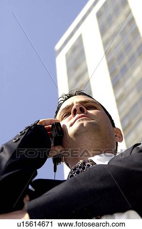 Stock Image - Businessman talking on cell phone. Fotosearch