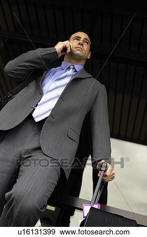 Stock Photo - Businessman talking on cell phone. Fotosearch