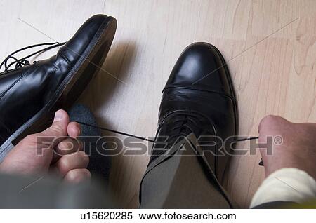 Businessman tying his shoes View Large Photo Image Stock Photography - Businessman tying his shoes. Fotosearch