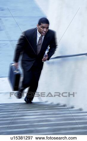Stock Photo - Businessman walking up stairs. Fotosearch