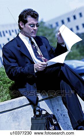 Stock Image - Businessman working outside. Fotosearch