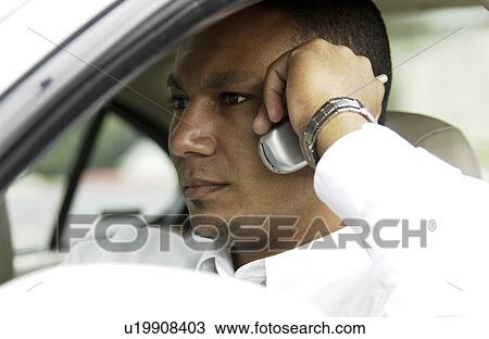 Man on cell phone in car View Large Photo Image Stock Image - Man on cell phone in car. Fotosearch