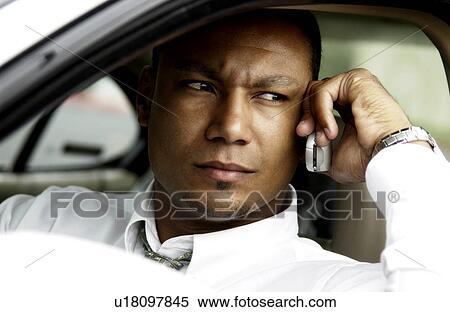 Man on cell phone in car View Large Photo Image Stock Photography - Man on cell phone in car. Fotosearch