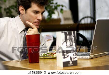 Stock Image - Man working on laptop. Fotosearch